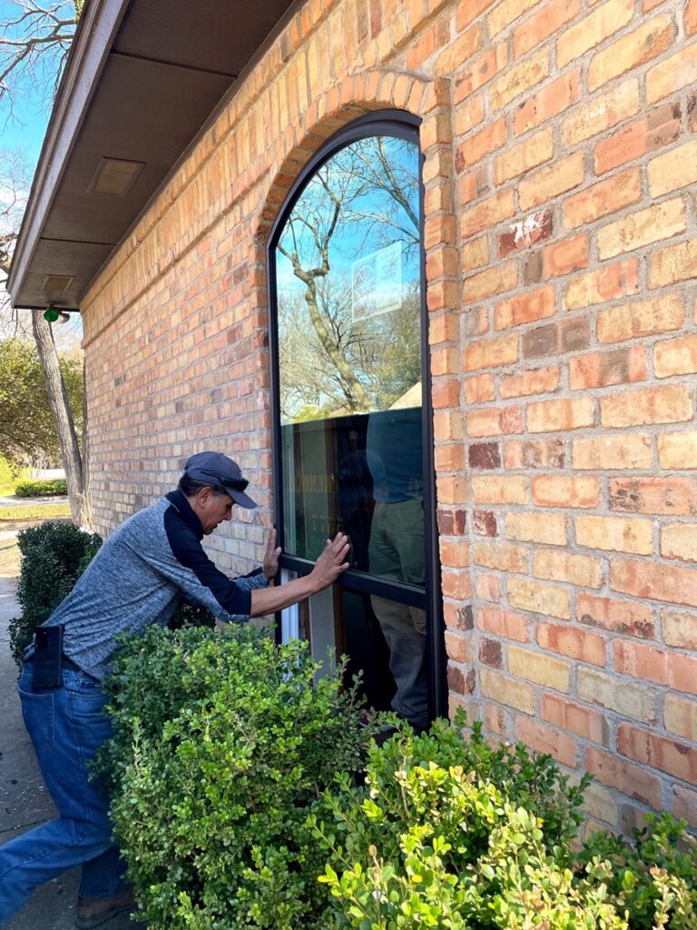 A-man-installing-energy-efficient-picture-replacement-windows-in-Seattle-WA